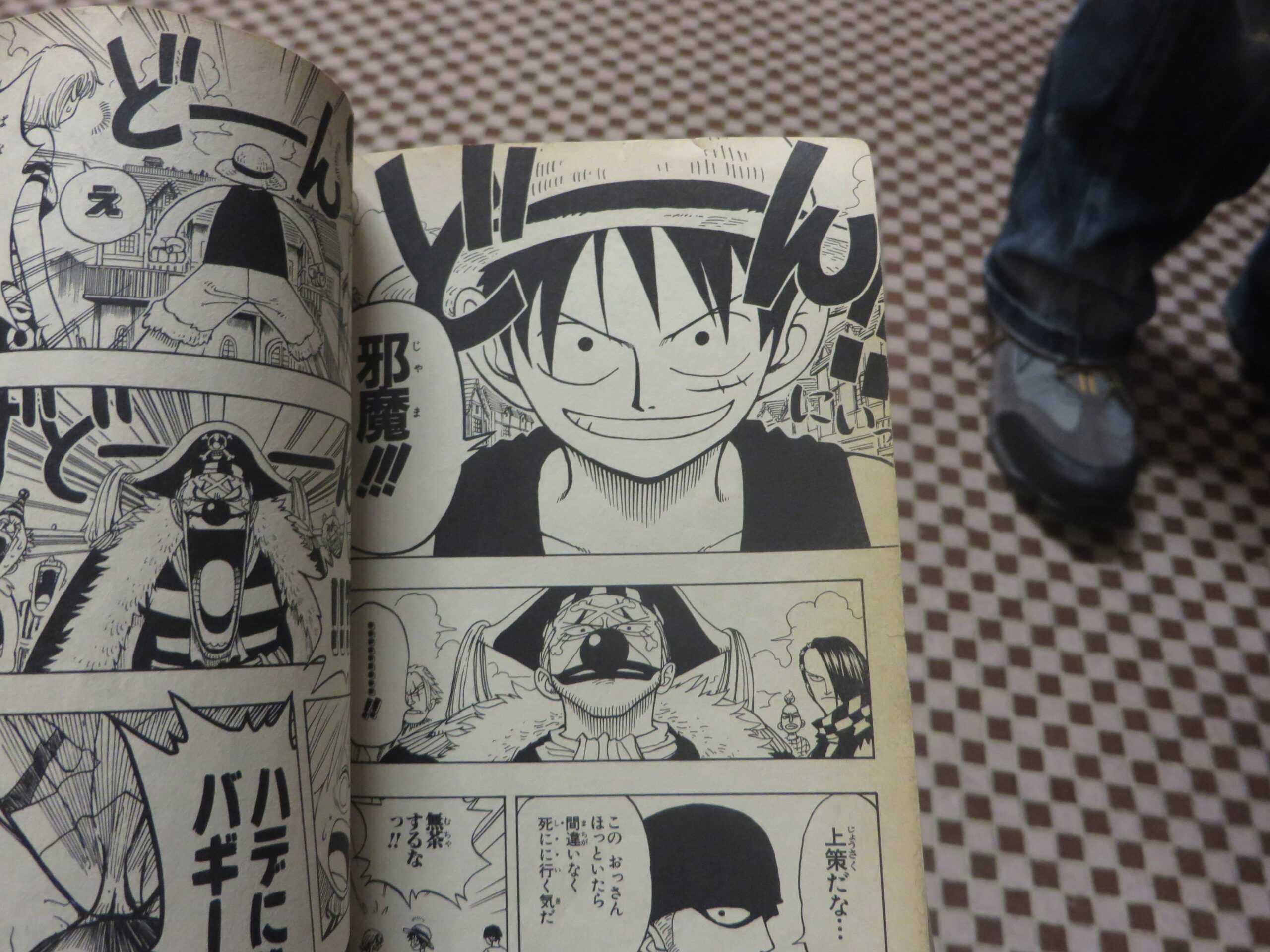 One Piece manga featuring Luffy and Buggy - photo taken at Kyoto International Manga Museum
