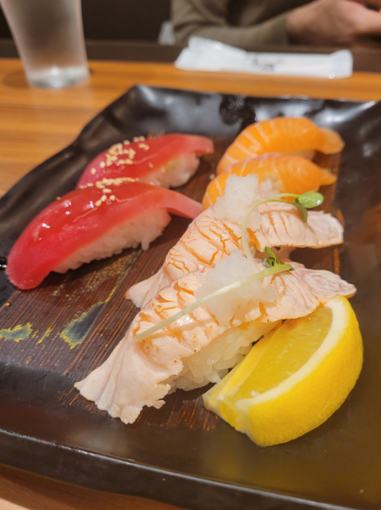 Delicious salmon, tuna, and prawn nigiri sushi at Nigiri Chojiro in Kyoto, Japan.